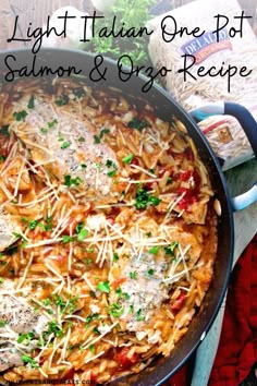 a pan filled with pasta and cheese on top of a red cloth next to bread