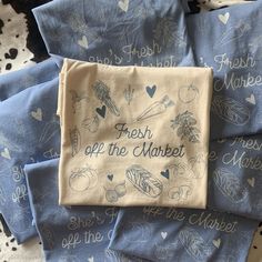 blue and white napkins with words on them sitting on top of a tablecloth