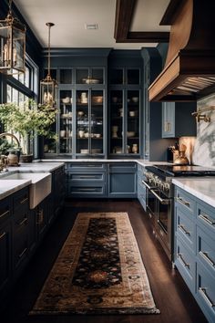 a kitchen with blue cabinets and an area rug on the floor in front of it