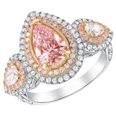 This three stone engagement ring is as rare as they come with an exotic 1.35 cts of light pink center stone and two colorless pears shapes as side stones surrounded by thousands of white and pink round diamond pave on the setting. GIA CERTIFIED Metal: 18k Gold Diamond Cut Center Stone: Pear Shape Diamond Cut Side Diamonds: Pear Shape, Round Brilliant Cut Diamond Cut: Very Good Total Diamond Carats: 2.55ct (Center Diamond 1.35ct) Diamond Clarity: VS1-VS2 Diamond Color: Fancy Light Pink, E-F Ring Pear Shaped Halo Engagement Ring, Pink Stone Engagement Rings, 18k Gold Engagement Ring, Pear Shaped Diamond Engagement Rings, Fancy Light, Expensive Jewelry Luxury, Colored Engagement Rings, Modern Engagement Rings, Expensive Jewelry