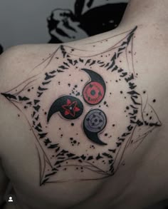 the back of a man's shoulder with three circles and stars on it, all in black ink