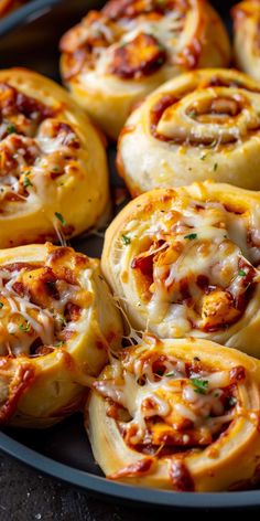 several mini pizzas with cheese and sauce in a blue dish on a table top