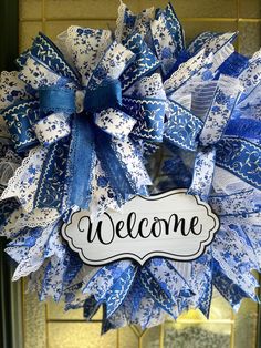 a blue and white wreath with the word welcome on it