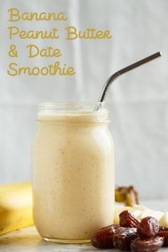 a banana, peanut butter and date smoothie on a white table with bananas in the background