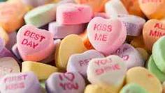 candy hearts with the words kiss me and you mine written on them in different colors