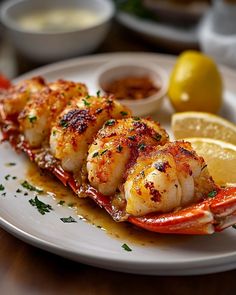 a white plate topped with shrimp and lemon slices