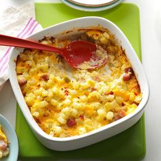 a casserole dish with eggs and ham in it on a green place mat