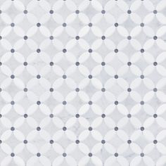 a white and gray wall with circles on it's surface, as well as dots