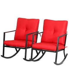 two red chairs sitting next to each other on top of a white surface with black frame