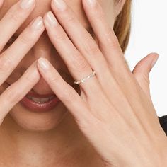 a close up of a person holding their hands to their face and covering her eyes