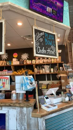 the inside of a food stand with signs above it