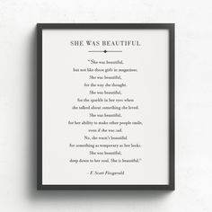 the poem she was beautiful is displayed in a black frame on a white wall above it