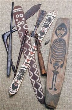 several different types of knives and other items laid out on a couch with the skeleton painted on them