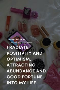 there are many items on the bed with text that reads, i radiate positivity and optimism attract abundance and good fortune into my life