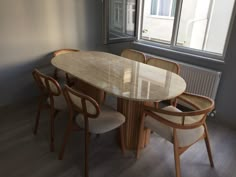 a table and chairs in front of a window