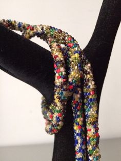 "Stunning lariat necklace from the 1920's with amazing beadwork and colors. In very good vintage vintage condition. Measurements are; From end to end 38 1/2\" Feel free to convo me with any further questions. Thank you for your interest." Adjustable Multicolor Beaded Lariat Necklace, Vintage Adjustable Beaded Necklace With 108 Beads, Vintage Beaded Necklace With 108 Beads For Gift, Multicolor Beaded Lariat Necklace With Round Beads, Adjustable Vintage Beaded Necklace, Vintage Multicolor Multi-strand Beads, Vintage Multicolor Beaded Jewelry, Unique Multicolor Lariat Necklace, Vintage Multicolor Faceted Beads Necklace