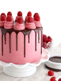 a cake with raspberries and chocolate on top