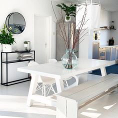 a white table and bench in a room