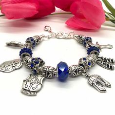 Put on the full Armor of God Charm Bracelet.  The Armor of God charms have an antique silver-style look to them and the spacer beads have a flower design. Spiritual Blue Metal Bracelets, Blue Metal Spiritual Bracelets, Handmade Blue Metal Charm Bracelet, Nickel-free Blue Metal Beaded Bracelets, The Full Armor Of God, The Armor Of God, Full Armor Of God, Armor Of God, Christian Jewelry