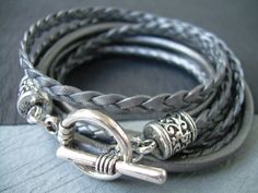 Style# TSB02TW - Get your metallic Gray/Silver on just in time for the Holidays! ... Super stylish and feminine. Wrap it three times around your wrist, toggle up and off you go. This Triple Wrap Leather Bracelet features 3mm round, 3mm braided and 5mm flat braided metallic leather cords. Lead and Nickel Free - Aged Silver Toned Alloy Components, Secure Toggle Closure for Easy on and off. All dyes used in our leather are certified 100% Lead-Free and meet all requirements of the German Goods Ordin Adjustable Silver Leather Bracelet With Lobster Clasp, Silver Leather Bracelet With Lobster Clasp For Everyday, Everyday Silver Leather Bracelet With Lobster Clasp, Handmade Silver Wrap Bracelet For Friendship, Handmade Silver Leather Friendship Bracelet, Everyday Silver Leather Bracelet Nickel Free, Adjustable Silver Wrap Bracelet For Everyday, Adjustable Silver Braided Bracelet With Lobster Clasp, Elegant Silver Leather Friendship Bracelet