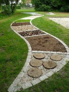 a stone path in the middle of a grassy area