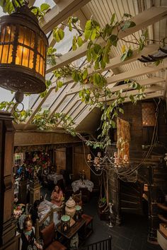 the inside of a restaurant with lots of people sitting at tables and eating in it