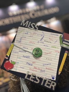 a graduate's cap with writing on it that says miss and has an apple