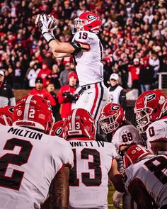 a football player jumping up into the air