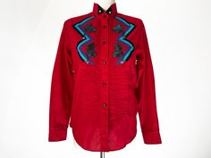 Amazing vintage western show shirt by WRANGLER Vibrant red pleated button-down dress shirt with black buttons. Gorgeous satin zig-zag appliqué patches on each side in purple, teal and black. Beautiful iridescent black beaded floral patches with beaded tassels-2 on leather side. Cutaway collar with black tips and silver beads. Such a beautiful top! In excellent vintage condition with age-appropriate wear-please see all photos Women's SMALL Bust: 38 Waist: 36 Hips: 37 Length: 26 inches Fitted Embroidered Red Shirt, Fitted Red Embroidered Shirt, Fitted Shirt For Western-themed Spring Events, Western Red Tops For Spring, Western Style Red Tops For Spring, Spring Western Red Tops, Western Show Shirts, Iridescent Black, Black Tips