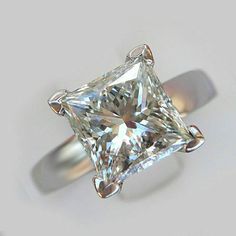 a ring with a princess cut diamond in it