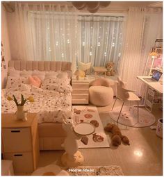 a bedroom with teddy bears on the floor and lights in the window behind it,