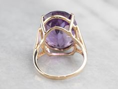 This ring is truly gorgeous! A large and beautiful saturated purple amethyst sits in the center, with an amazing cut and vibrant color that flickers with bright pops of violet! The stone is expertly cut to really display the stone’s color and sparkle. The simple mounting and prongs are all this stone needs to frame it to perfection! Metal: 10K Yellow Gold Gem: Amethyst 17.48 Carats Gem Measurements: 18.7 x 14.9 mm, Oval Ring Size: 5.75 Marks: "CID10K" Stamped on the inside band Elegant Purple Amethyst Ring With Large Stone, Faceted Purple Amethyst Ring For Formal Occasions, Formal Faceted Purple Amethyst Ring, Amethyst Cocktail Ring, Oval Ring, Oval Rings, Cocktail Ring, Eternity Bands, Purple Amethyst