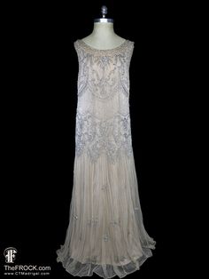 💄After 23 years, our website, TheFROCK.com, has had a makeover. Check out the new site, and join our mailing list for new arrivals.     Vintage Bonwit Teller heavily beaded and sequined sleeveless palest beige/dark ivory net evening gown or wedding dress. Sleeveless, rear zipper, poly jersey lined. The garments has a relaxed 1930s or 1920s flapper style fit that will work for many sizes, the fabric has some stretch: bust will comfortably stretch from 36" to 42", waist stretches from 38" to 41", 1920s Embellished Flapper Dress For Wedding, Sleeveless Flapper Dress For Gala, Embellished Flapper Wedding Dress, Gatsby Style Fitted Wedding Evening Dress, Fitted Gatsby Style Wedding Evening Dress, Gatsby Style Sleeveless Gala Evening Dress, Sleeveless Gatsby Dress For Vintage Events, Gatsby Style Sleeveless Flapper Dress For Vintage Events, Art Deco Sleeveless Dress For Vintage Events