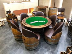 a poker table surrounded by chairs and barrels