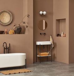 a bath room with a tub a sink and a mirror on the wall in it