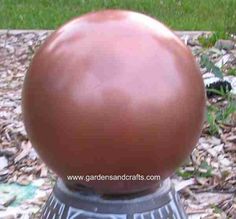 a brown ball sitting on top of a metal object