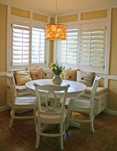 a dinning room table with chairs and a chandelier