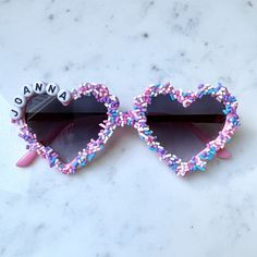 Personalized Sunglasses for girls are perfect for birthday gifts and party favors! These glasses are completely customizable! More sprinkle colors coming soon!!  🌿How to Order🌿 *Choose Color of Glasses *Choose Letter Bead Color  *In personalization box enter the name or word of your choice *If you have a special request for additional beads like hearts or stars, please let me know! Glasses will fit 0-6 years of age approximately.  Frame is made of plastic.  Several sprinkles may fall off during shipping, this is normal.  The sprinkles are glued down and will typically stay put unless pulled off. Birthday Sunglasses, Bride Sunglasses, Valentine Name, Beaded Sunglasses, Handmade Sunglasses, Personalized Sunglasses, Heart Shaped Glasses, Custom Sunglasses, Heart Glasses