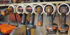 several cordless drillers are lined up on the wall