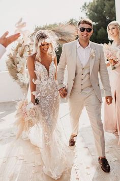 a bride and groom walking down the aisle