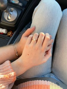 a person holding their hand on the seat of a car