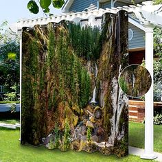 an outdoor shower curtain with a waterfall in the middle