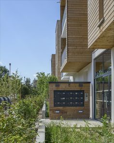 an apartment building with wooden siding and windows