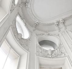 an ornate ceiling with three round windows