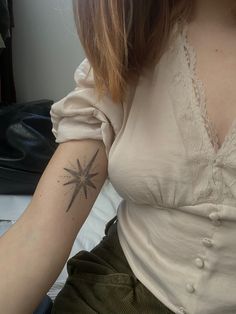 a woman with a star tattoo on her arm