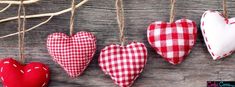 four red and white heart ornaments hanging from a branch on a wooden background with text overlay