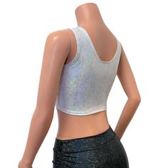 Silver on white holographic ring front crop top for your festival or rave outfit. This sleeveless crop top fits snug to the body and sits above the belly button with a metal ring detail in front. Pair with your favorite high waist skater skirt or holographic cheeky for the perfect rave set. Metallic Fitted Trendy Crop Top, Trendy Fitted Metallic Crop Top, Fitted Metallic Crop Top For Summer, Fitted Disco Crop Top, Sleeveless Silver Crop Top For Club, White Cropped Tank Top For Party, Metallic Fitted Disco Crop Top, Sleeveless Rave Crop Top For Festival, Fitted Cropped Disco Top