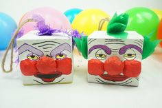 two boxes with clown faces painted on them