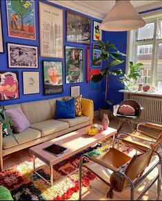 a living room filled with furniture and lots of pictures on the wall above it's coffee table