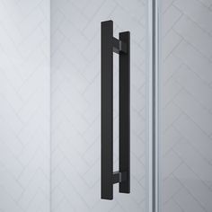 an image of a black door handle on a white wall with geometric tiles in the background